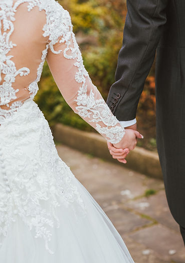 bride and groom holding hands after getting married