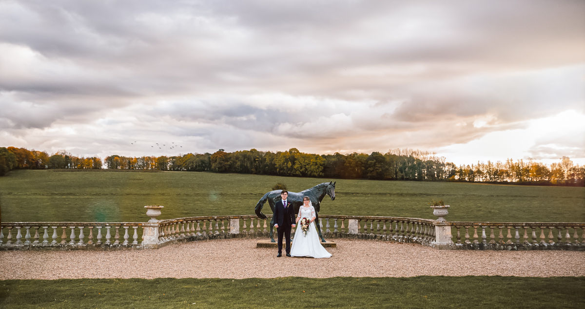 bride and groom holding hands at sunset - affordable wedding photography